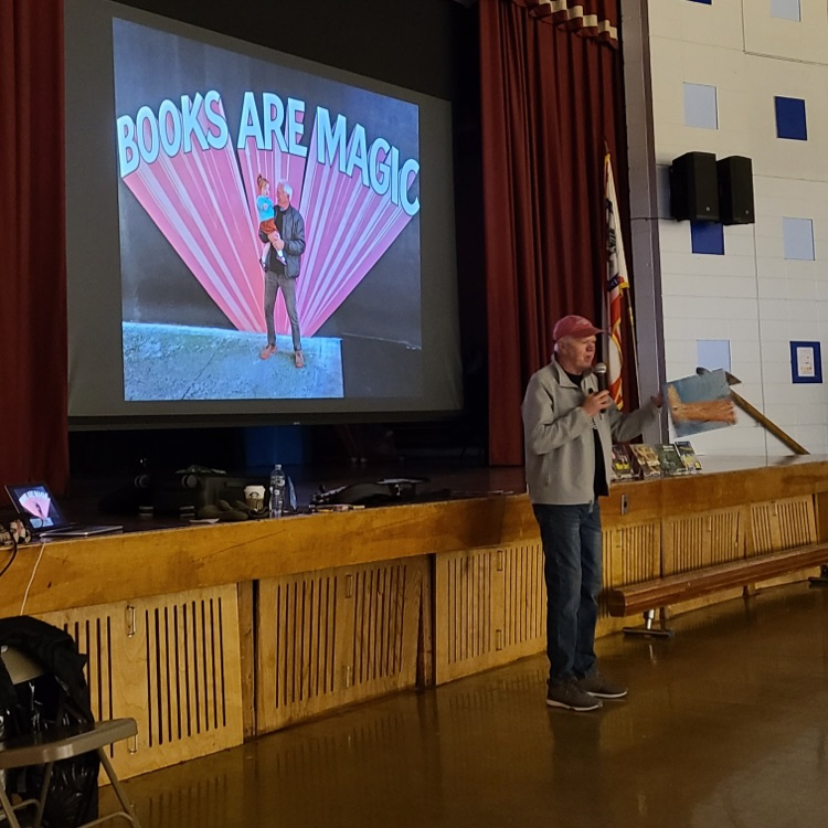 Man presenting in front of a screen