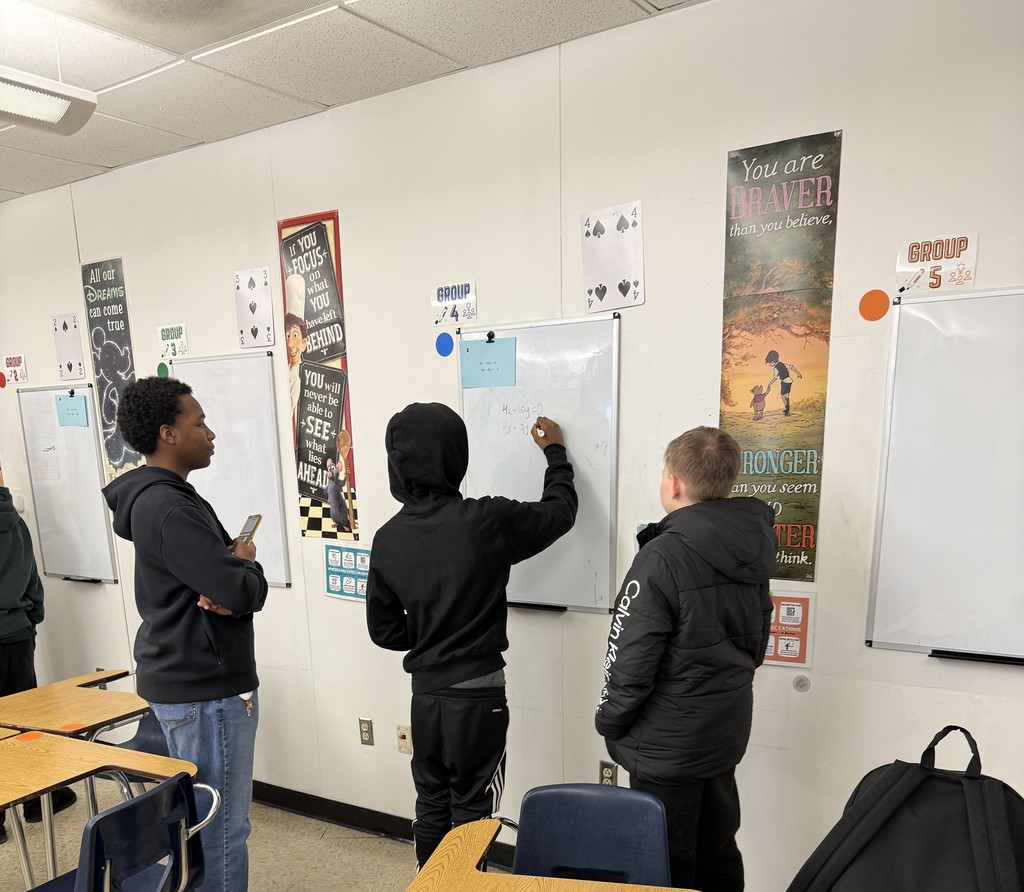 Students solving systems of equations