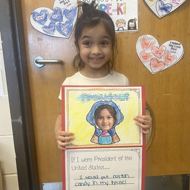 Preschool student holding if I were president poster