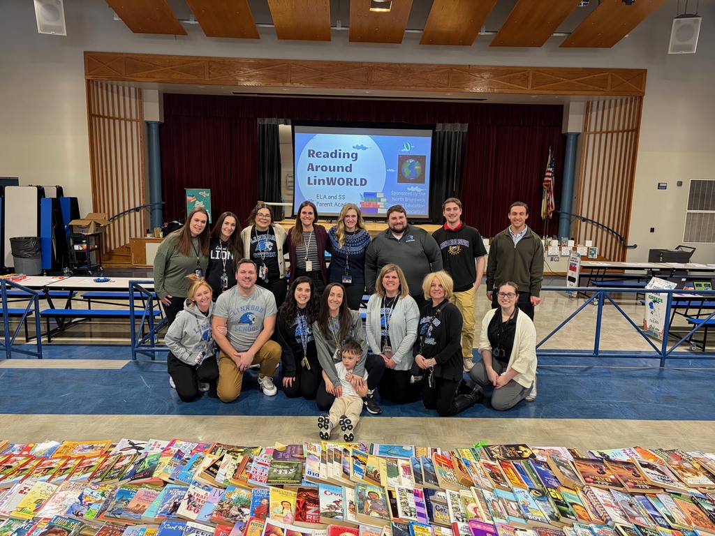 Group of teachers posting in front of books