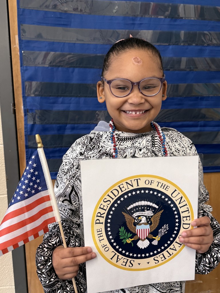 Student pretending to be president with a flag and official seal