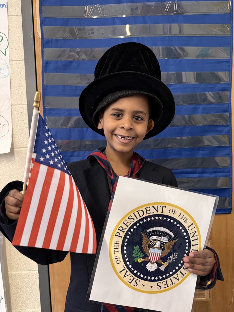 Student pretending to be president with a flag and official seal