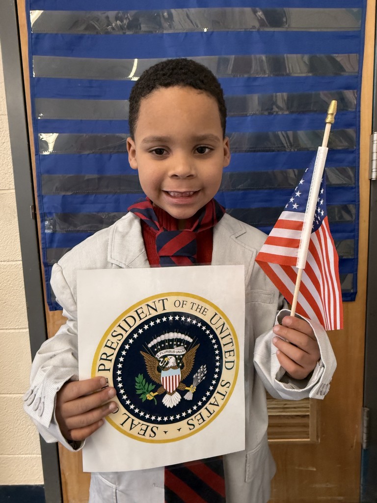 Student pretending to be president with a flag and official seal