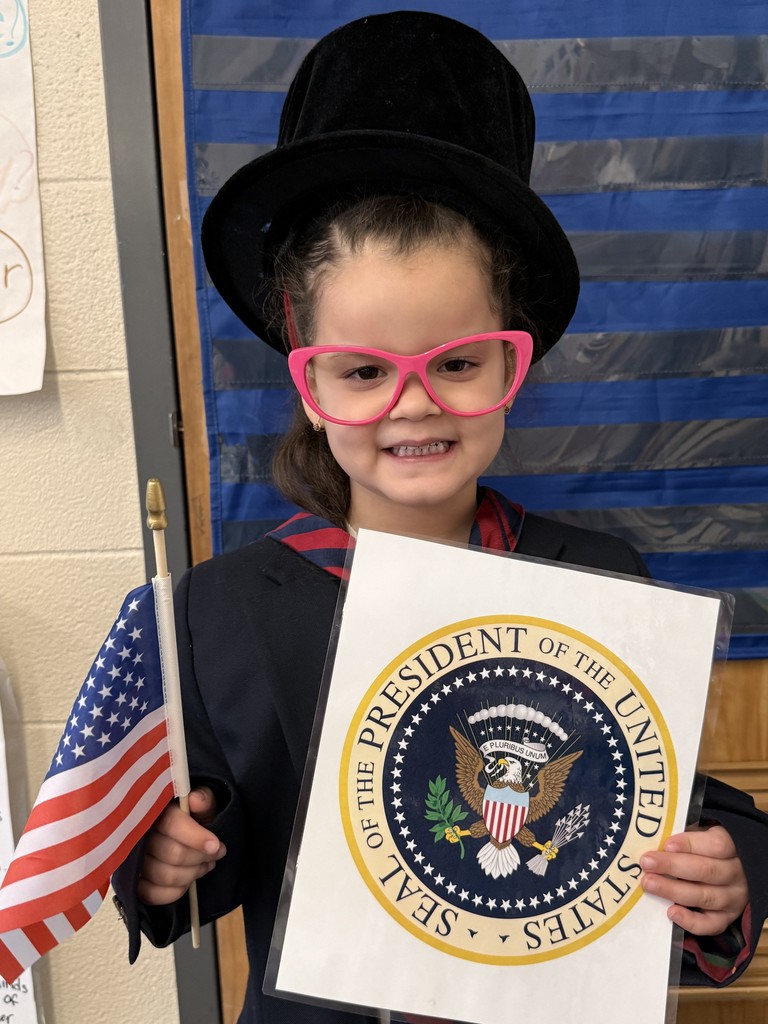 Student pretending to be president with a flag and official seal