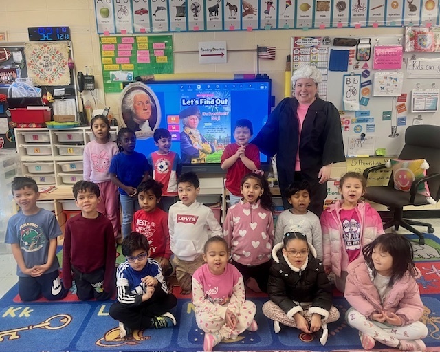 students in a group in a classroom with person dressed up as George Washington