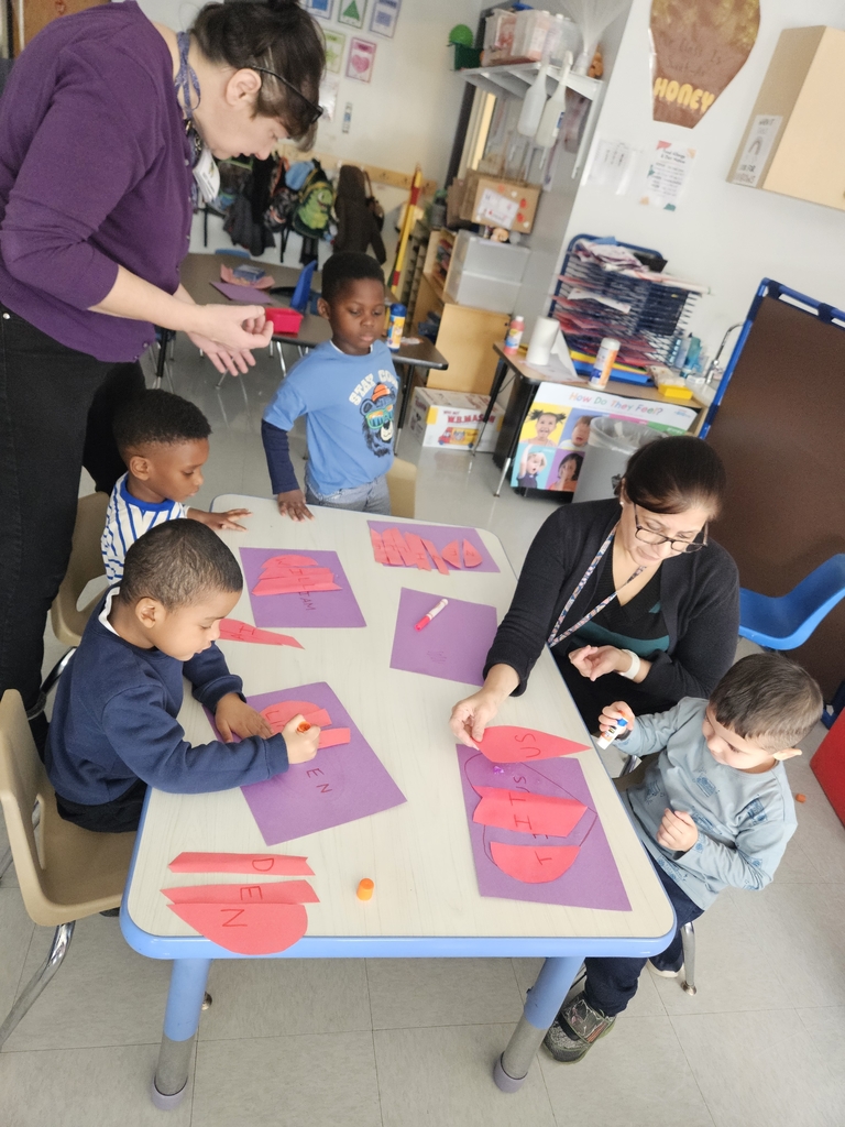 kids at a table making heart names