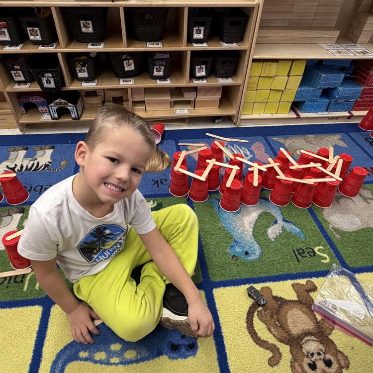 Student building with shapes on the floor