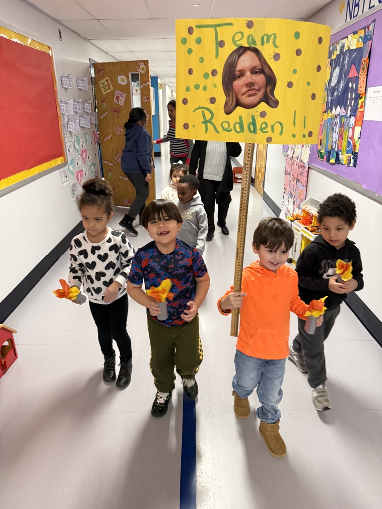 Group of four students carrying a sign