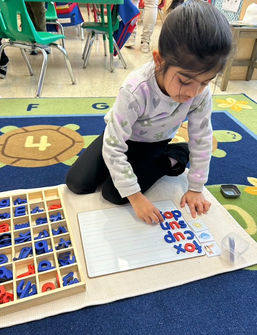 child using magnetic letters 