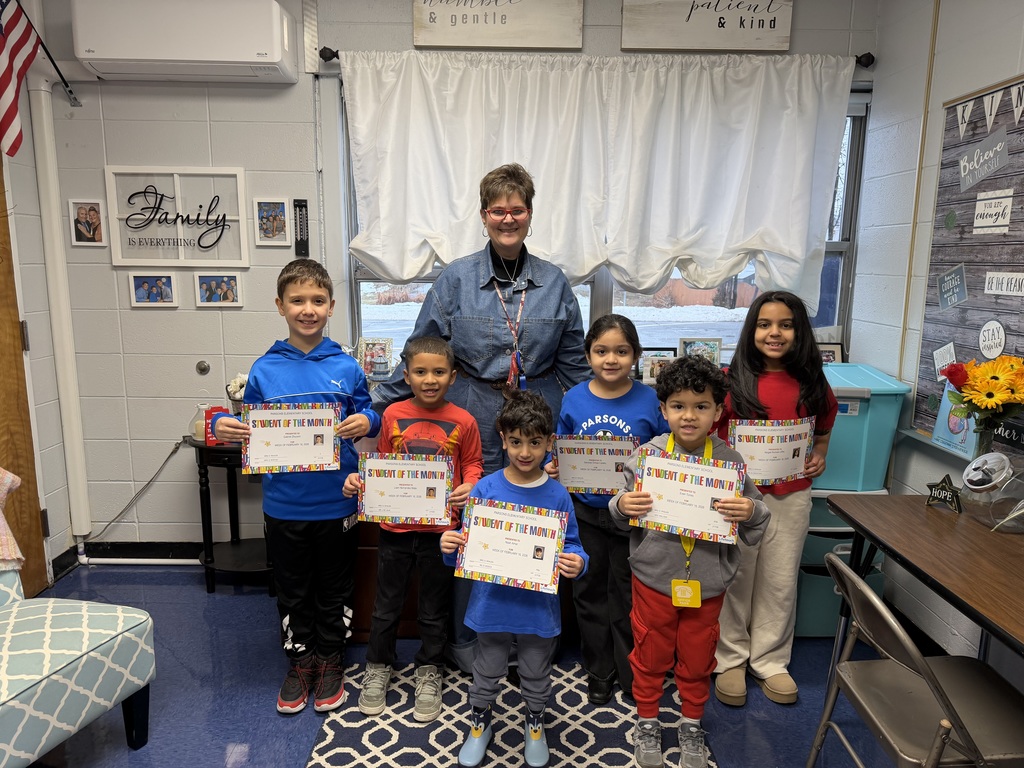 Group of students standing with certificates with the principal