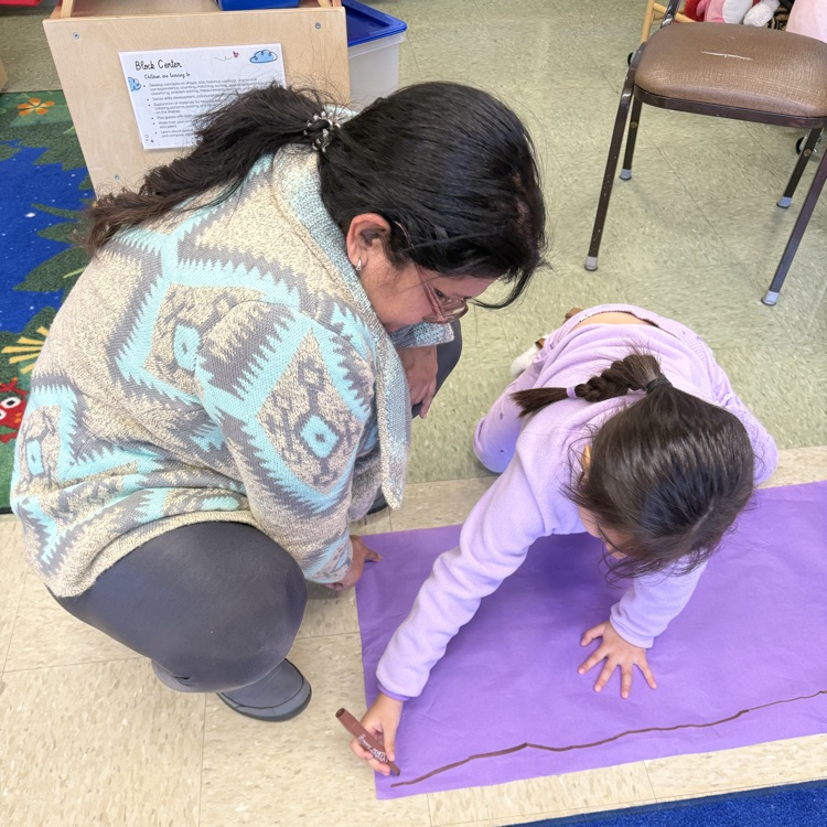 Student working on purple poster
