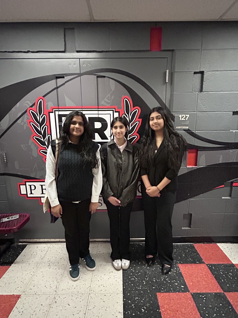 Three members of the Speech & Debate Club who competed in the district qualifier for Congress stand in front of a mural by the Bridgewater-Raritan High School auditorium.s