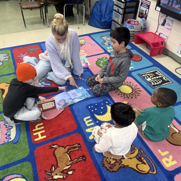 Students sitting on the floor reading