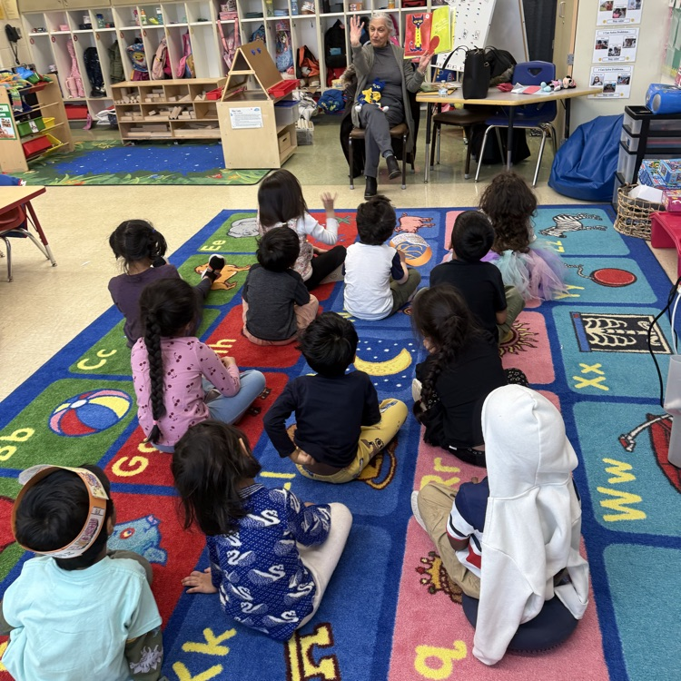 Students listening to a guest reader