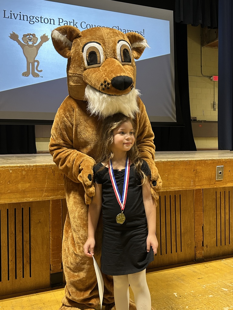 students posing with a school mascot