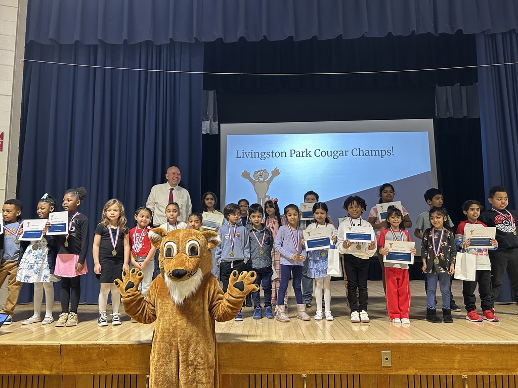 Large group of students posing with certificates and a school mascot