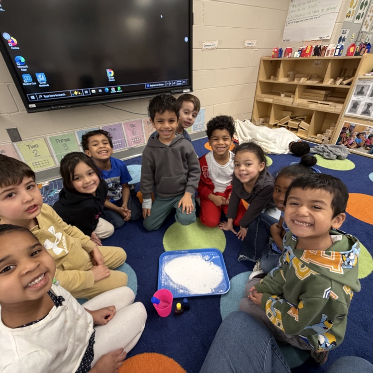 Students smiling around a science experiment
