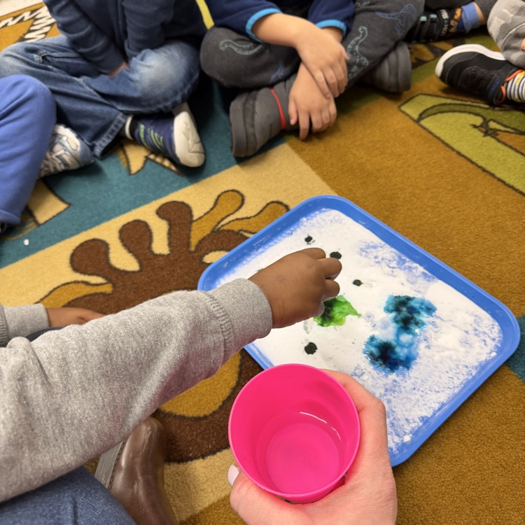 Students mixing colors in science experiment