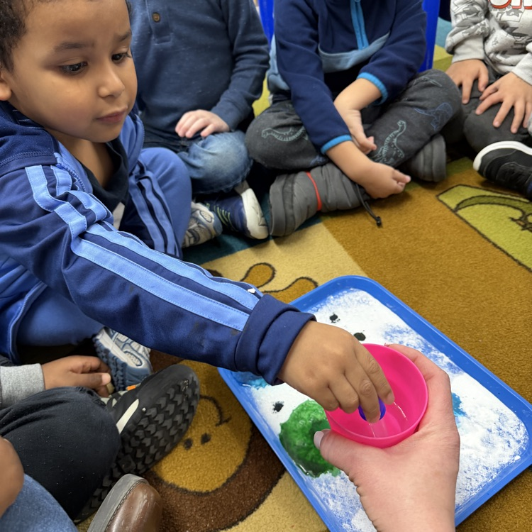 Students mixing colors in science experiment