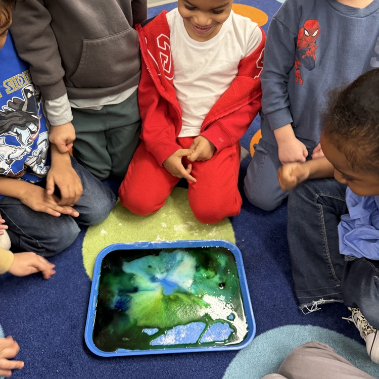 Students mixing colors in science experiment