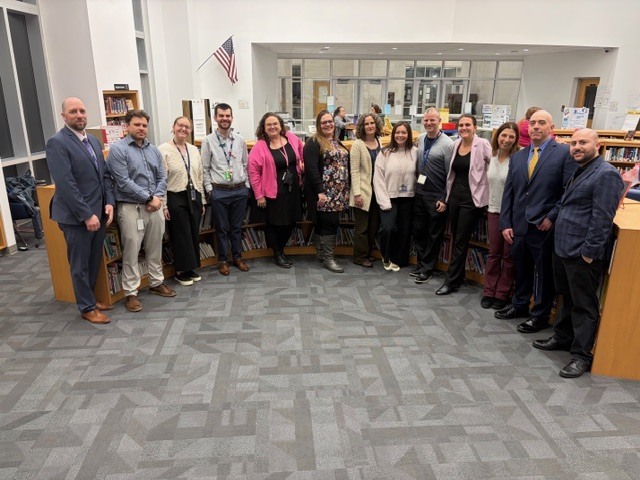 Teachers standing together in a library