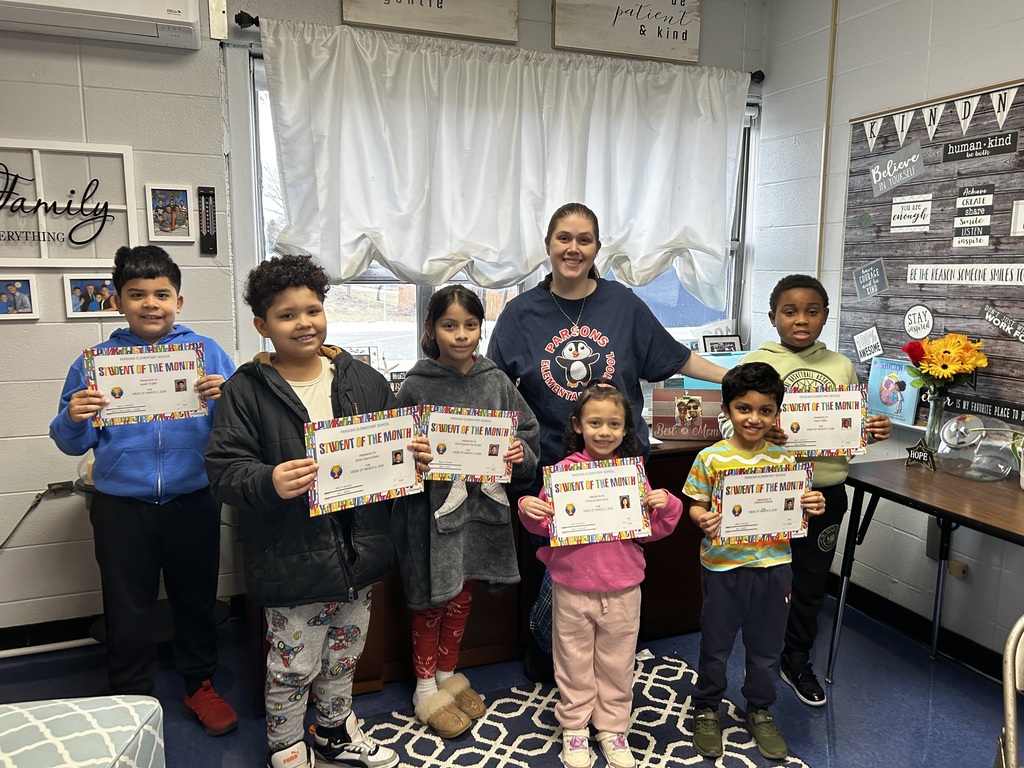 Students standing with their principal - holding certificates
