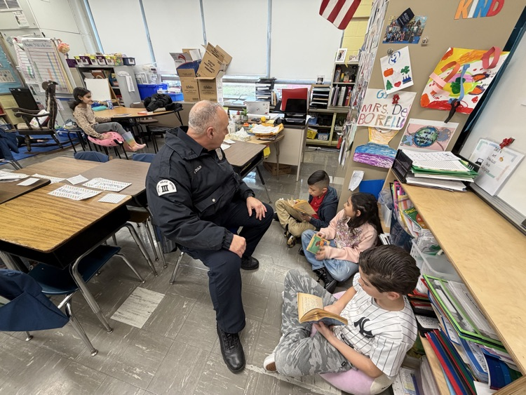 Students reading with a police officer