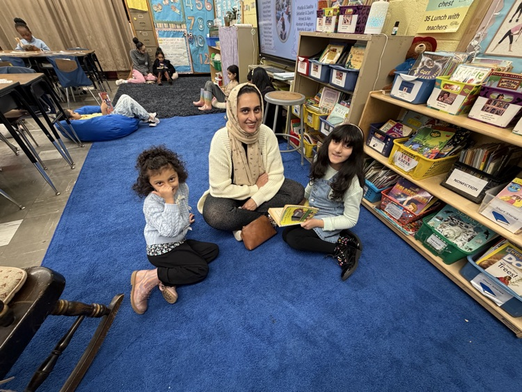 Students and adult reading in a classroom