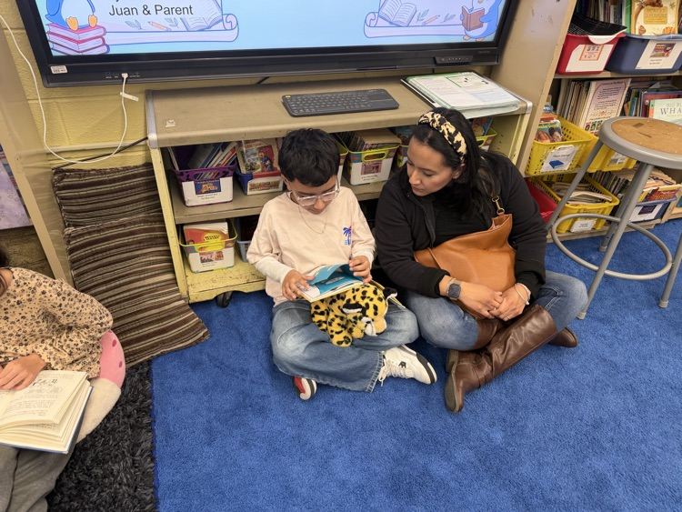 Students and adult reading in a classroom