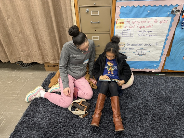 Students and adult reading in a classroom