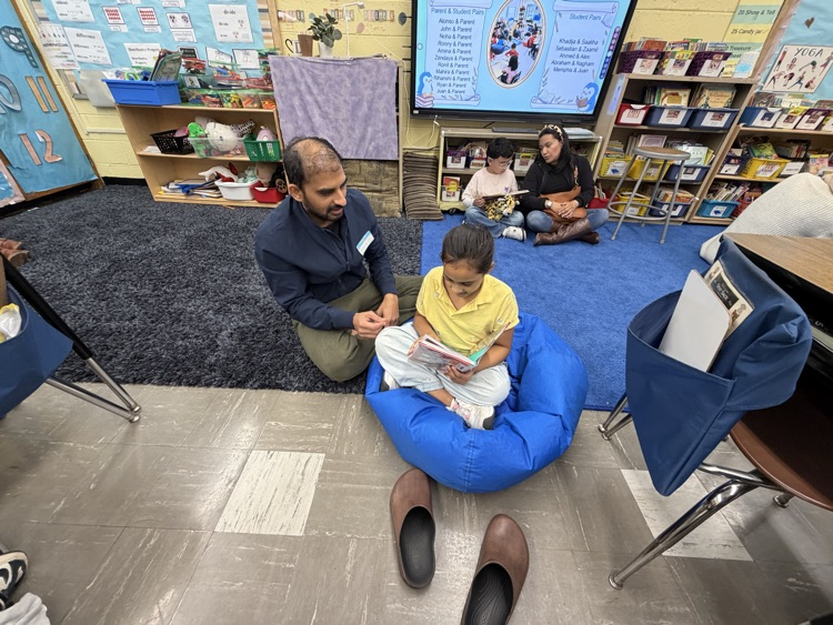Students and adult reading in a classroom
