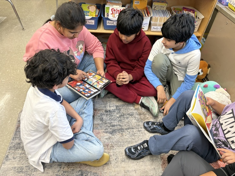Students reading with their parents  in the classroom