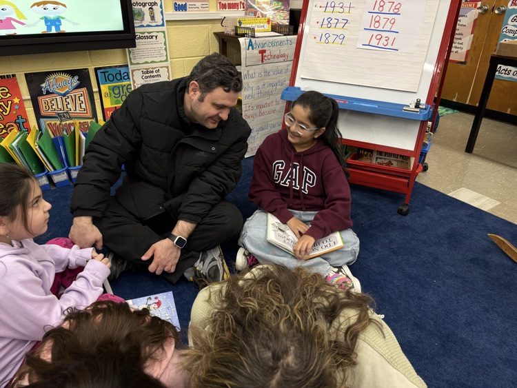 Students reading with their parents  in the classroom