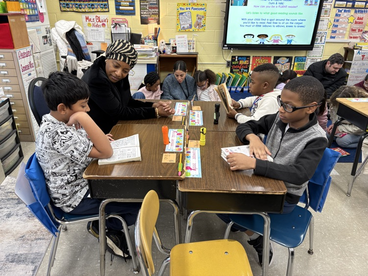 Students reading with their parents  in the classroom