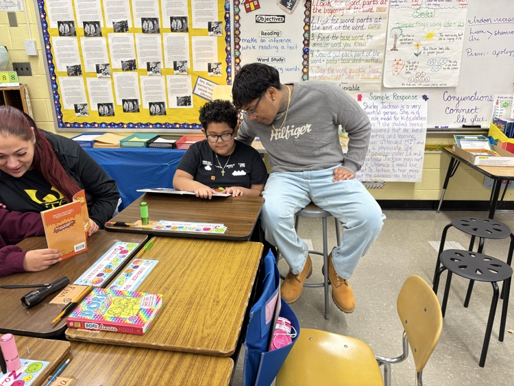 Students reading with their parents  in the classroom