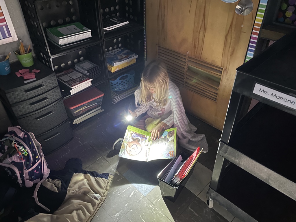Students reading with flashlights
