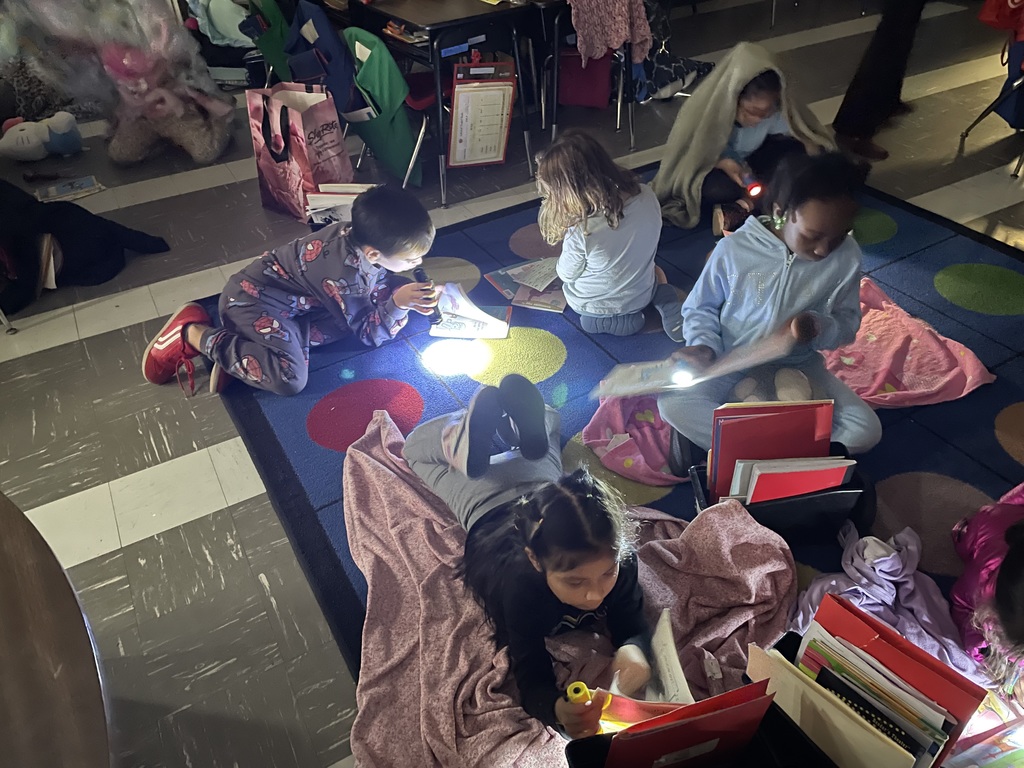Students reading with flashlights