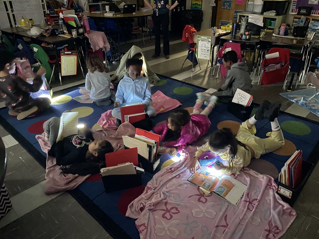 Students reading with flashlights