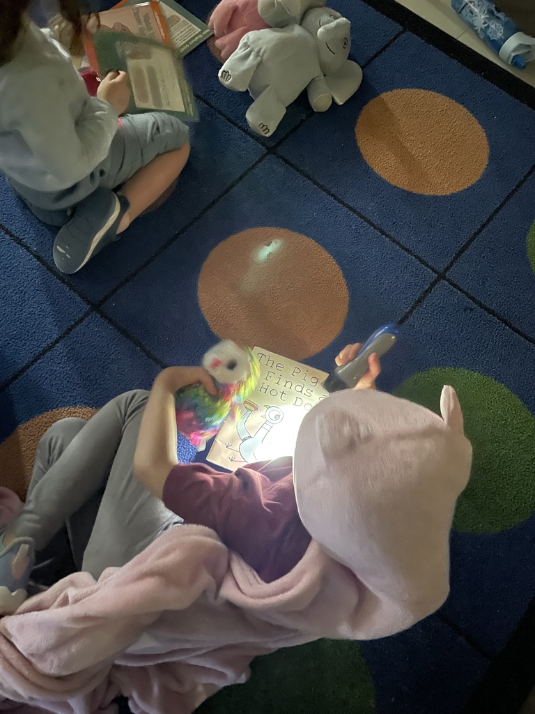 Students reading with flashlights