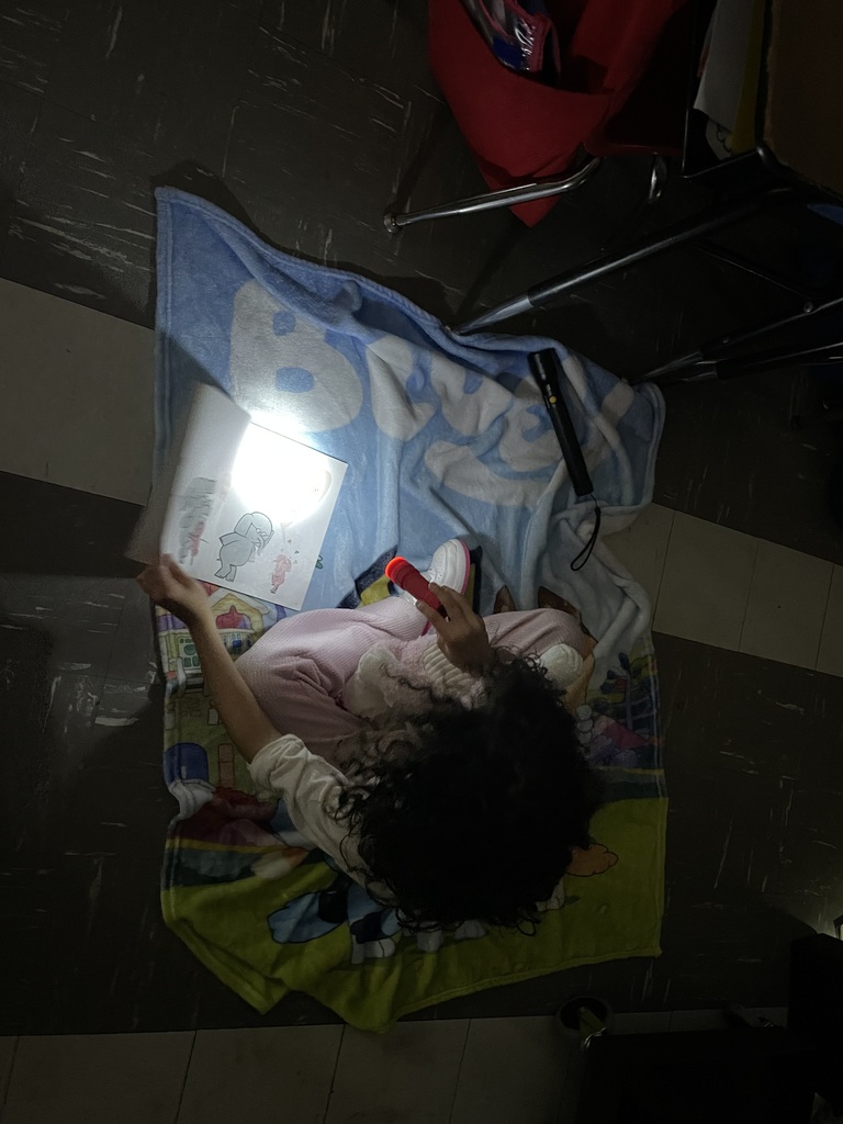Students reading with flashlights