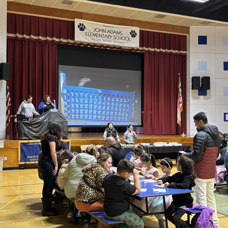 families playing bingo in a school cafeteria