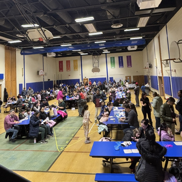families playing bingo in a school cafeteria