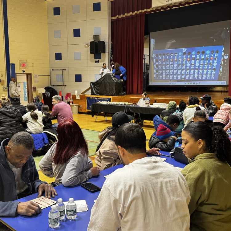 families playing bingo in a school cafeteria