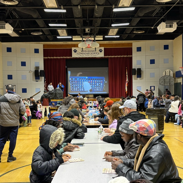 families playing bingo in a school cafeteria