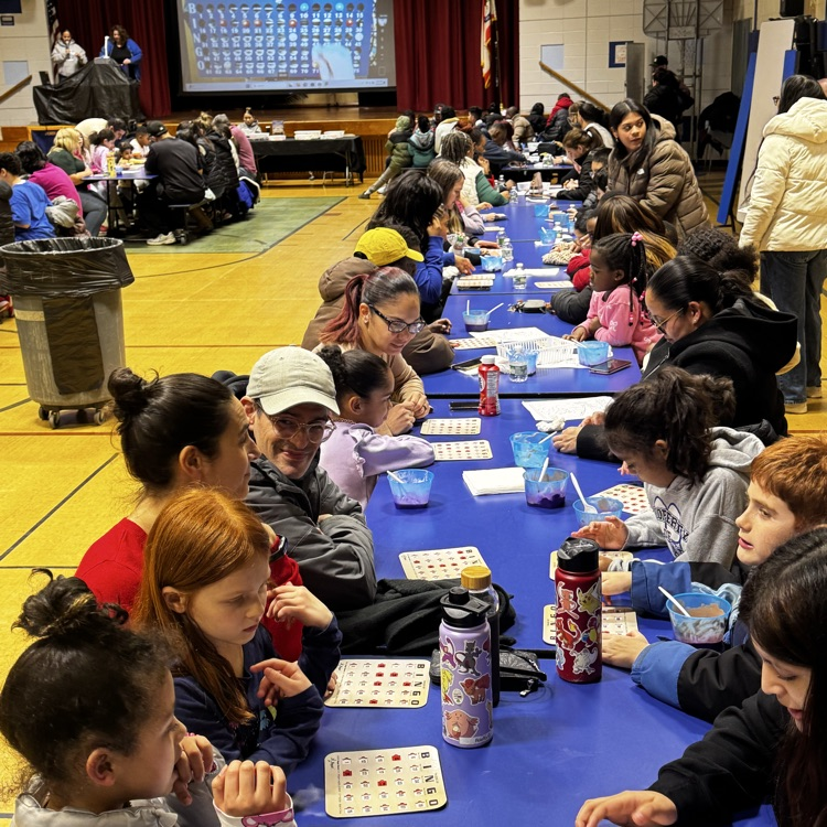 families playing bingo in a school cafeteria