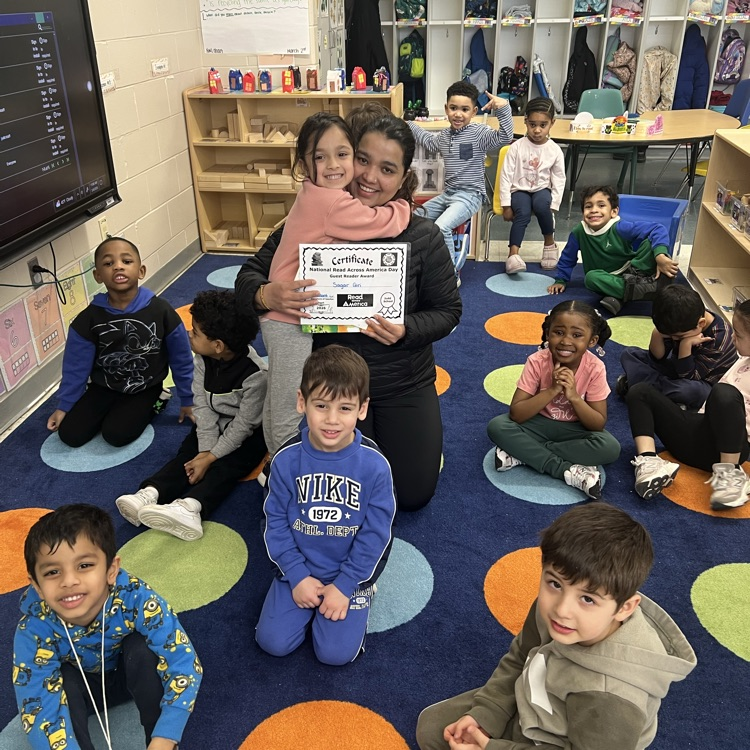 Students sitting on a carpet in a classroom