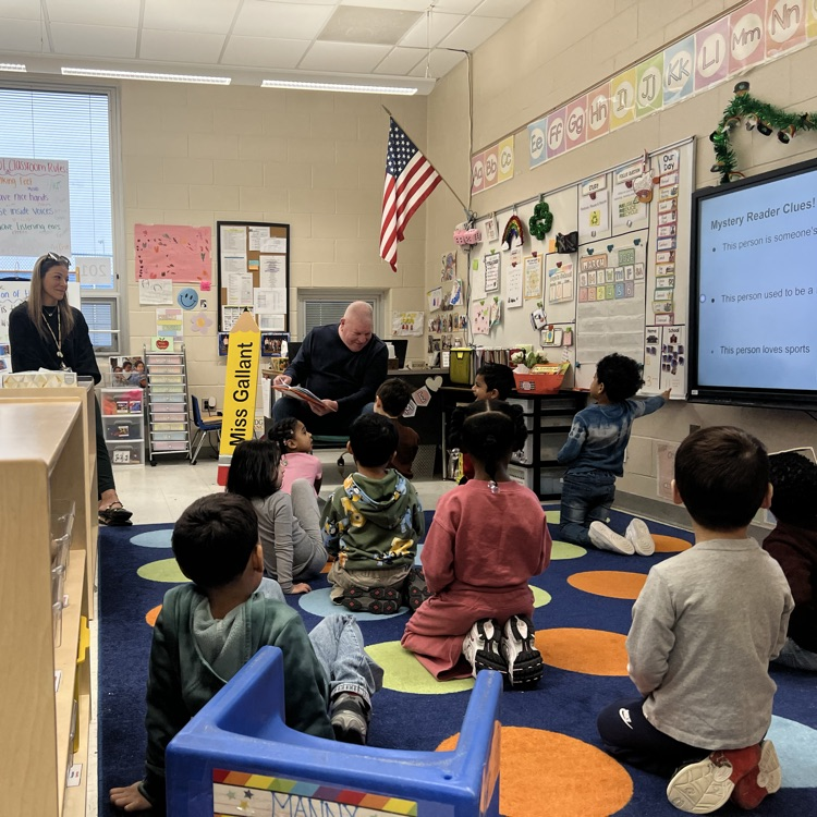 Students sitting on a carpet in a classroom