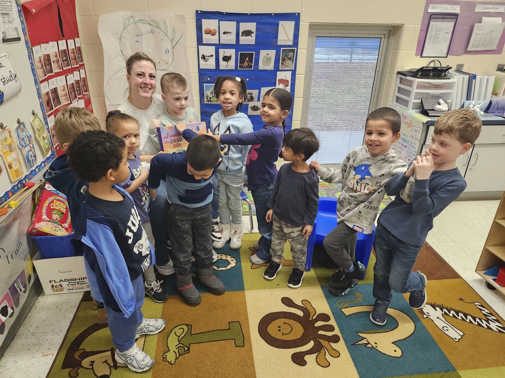 Mystery Readers Story time. Parent standing with group of students
