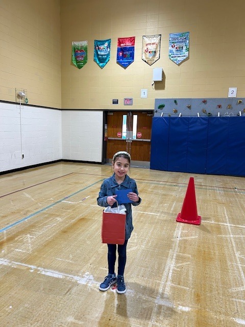 Student standing with giftbag