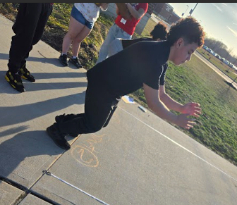 Students jumping and measuring their distances.